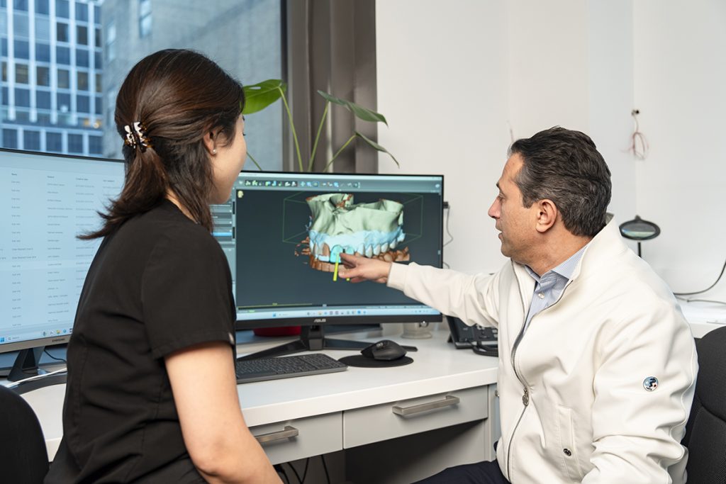 Dr. Navid Examining 3d Rendering of Tooth Structure