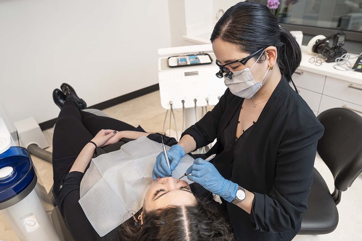dentist performing root canal treatment procedure for infected tooth at NYC Dentistry Center in Midtown Manhattan