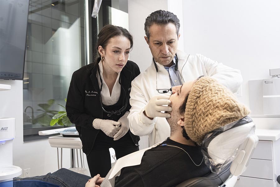 Dr. Navid Rahmani DDS periodontist performing periodontal disease evaluation in Midtown East NYC dental office