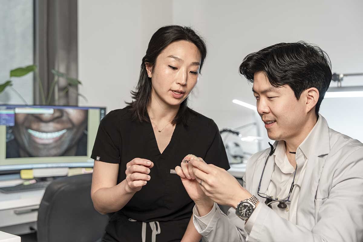 Prosthodontist planning full mouth reconstruction treatment with patient in Midtown East NYC dental office