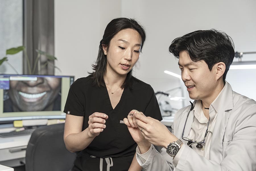 prosthodontist explaining full and partial dentures treatment options to patient in Midtown Manhattan NYC dental office