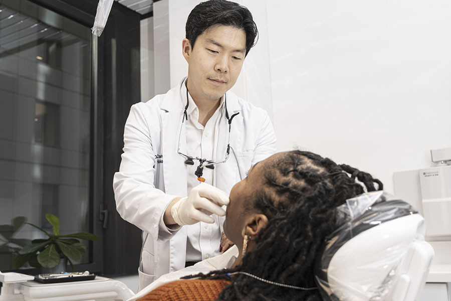 Dentist examining a patient for a cavity or hole in tooth at NYC Dentistry Center in Midtown East Manhattan