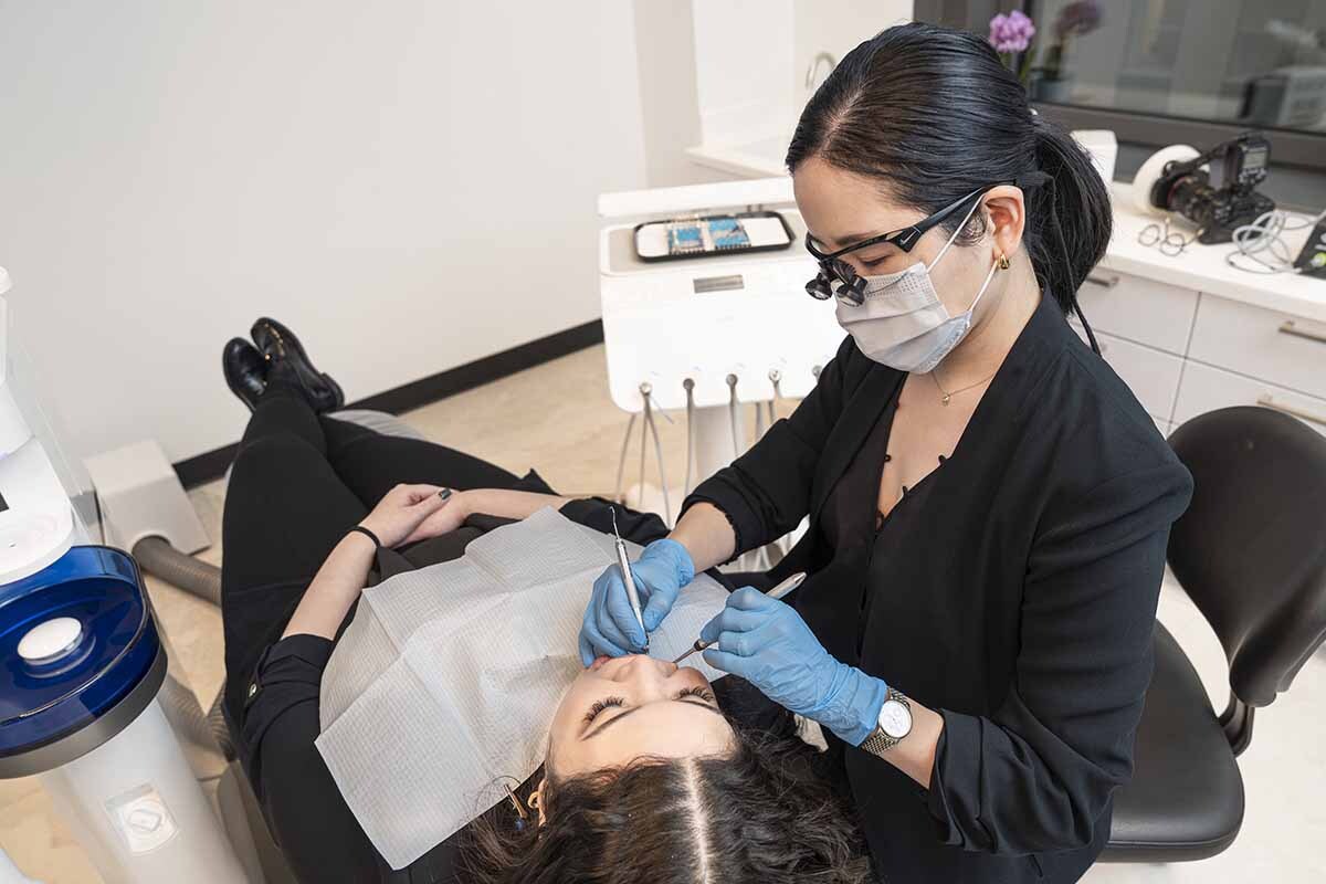Dentist performing precise dental fillings treatment on patient in modern Midtown NYC dental office