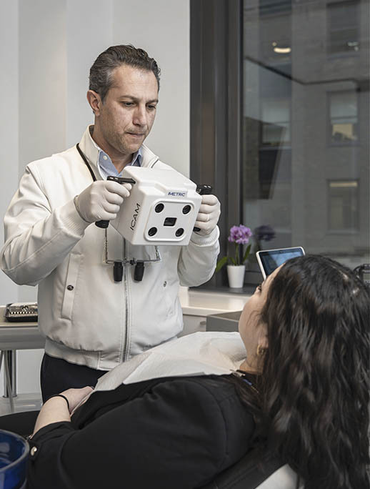 Dentist performing digital dental scan and diagnostic evaluation for tooth infection in Midtown Manhattan NYC